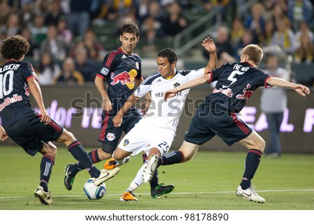 CARSON, CA. - MAY 7: Los Angeles Galaxy M Miguel Lopez #25 tries to work his way around the Red Bulls defense during the MLS game on May 7 2011 at the Home Depot Center in Carson, CA.