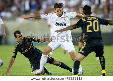 LOS ANGELES - JULY 16: Real Madrid C.F. M Mesut Ozil #23 tries to beat the Galaxy defense during the World Football Challenge game on July 16 2011 at the Los Angeles Memorial Coliseum in Los Angeles.