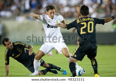 LOS ANGELES - JULY 16: Real Madrid C.F. M Mesut Ozil #23 tries to beat the Galaxy defense during the World Football Challenge game on July 16 2011 at the Los Angeles Memorial Coliseum in Los Angeles.