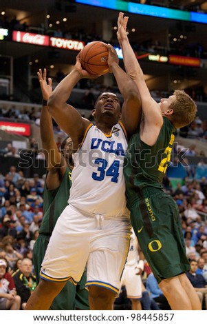 LOS ANGELES - MARCH 10: UCLA Bruins C Joshua Smith #34 &  Oregon Ducks forward E.J. Singler #25 during the NCAA Pac-10 Tournament basketball game on March 10 2011 at Staples Center.