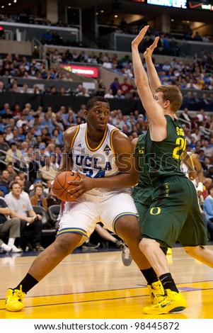 LOS ANGELES - MARCH 10: UCLA Bruins C Joshua Smith #34 & Oregon Ducks F E.J. Singler #25 during the NCAA Pac-10 Tournament basketball game on March 10 2011 at Staples Center.