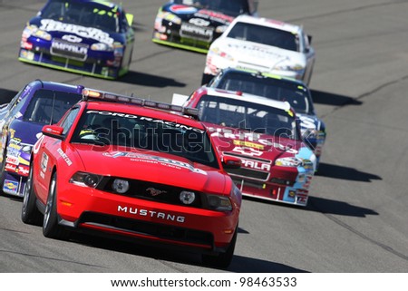 FONTANA, CA. - OCT 10: The Ford Mustang pace car leads the pack during the Pepsi Max 400 on Oct 10 2010 at the Auto Club Speedway in Fontana, Ca.