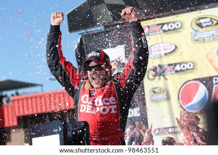 FONTANA, CA. - OCT 10: Sprint Cup Series driver Tony Stewart shows everyone who\'s number 1 after winning the Pepsi Max 400 on Oct 10 2010 at the Auto Club Speedway.
