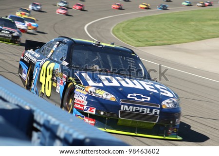 FONTANA, CA. - OCT 10: Sprint Cup Series driver Jimmie Johnson in the Lowe\'s #48 car leads the pack during the Pepsi Max 400 on Oct 10 2010 at the Auto Club Speedway.