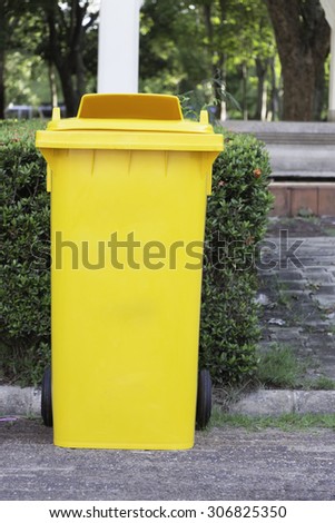 Large yellow trash can (garbage bin) with wheel