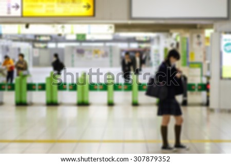 Blur of Female Japanese student waiting in the subway station