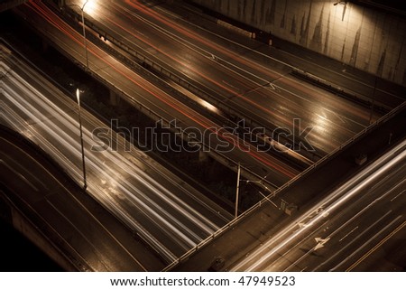 A birds eye view highway section shot at nighttime. Long exposure.