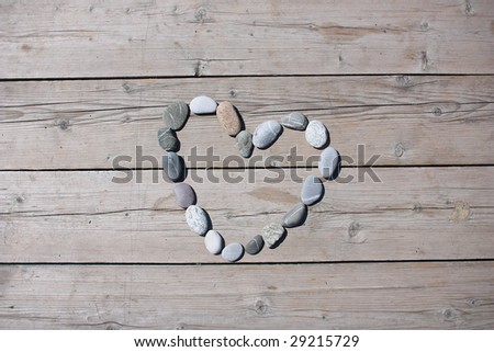 A heart shaped stone on a old wood planks