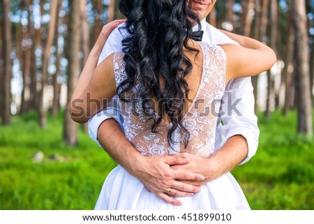 Groom embracing his bride back