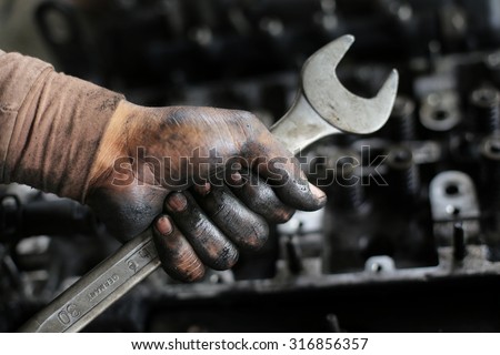 Mechanic with dirty hand from lubricant.
