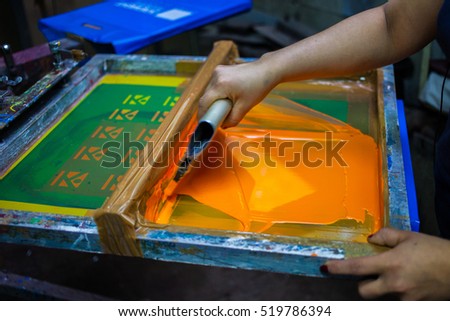 Press silk-screen printing by orange paint.\
Screen Print.