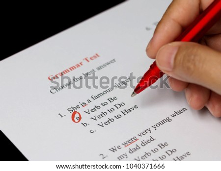 English grammar test sheet on black table
