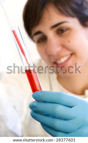 Lab Tech with red test tube shot over white background