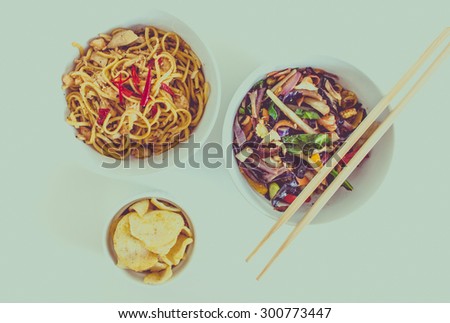 Chinese Meal of noodles, vegetables and prawn crackers