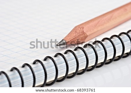 Wooden pencil on ring bound pad