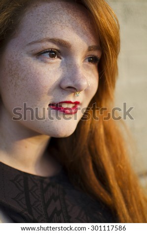 Red headed woman with nose ring.