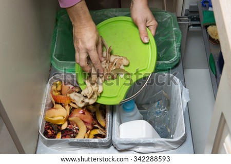 Household waste sorting and recycling kitchen bins in the drawer. Collecting food leftovers for composting. Environmentally responsible behavior, ecology concept.