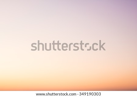 Over blur beautiful colorful sunset above sea and could sky texture background with boat and sun shine. color pink, blue, yellow, white pattern concept.