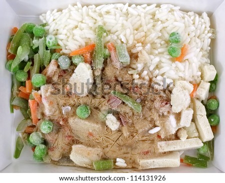 A stir fry chicken vegetable and rice frozen dinner.