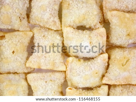 A close view of a layer of frozen stuffed pizza pastry snacks.