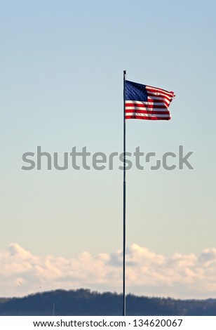 An American red white and blue flag flying in the breeze.