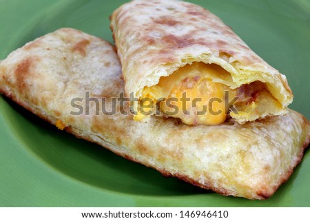 A nice view of a close bite of bacon egg and cheese pocket.