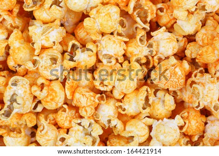 A close view of  tasty cheddar cheese popcorn with a hot sauce flavor.