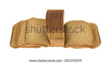 Top angled view of thin sliced whole wheat bread fanned out on a white background.