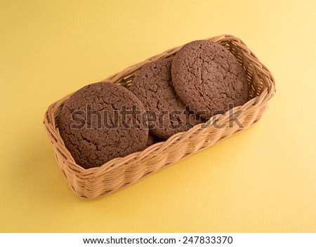 A small oblong wicker basket filled with Dutch Cocoa soft cookies.