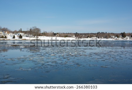 Ice breaking up in spring thaw across Searsport Maine waterfront.