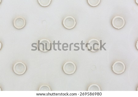 A close view of the suction cups on the back of a rubber bath mat.