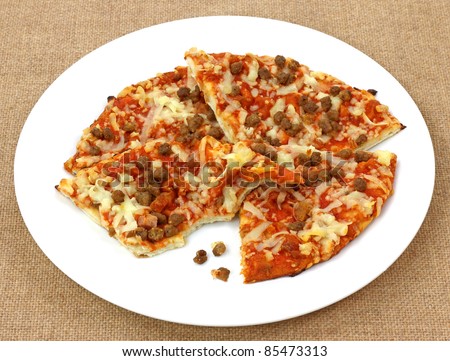 Stacked slices and taste of an individual three meat pizza.