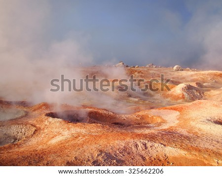 Boiling red mud pools in the geothermal area Sol de Manana in western Bolivia near Uyuni at an elevation of 15,900 feet resembling a landscape on planet mars.