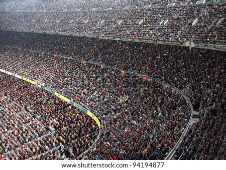 BARCELONA OCT 22 Spectators in a sold out Barcelona football stadium Camp Nou during the match between FC Barcelona and FC Sevilla on October 22 2011 in Barcelona BARCELONA OCT 22 Spectators in a sold out Barcelona football stadium Camp Nou during the match between FC Barcelona and FC Sevilla on October 22 2011 in Barcelona