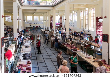 FUNCHAL, PORTUGAL - MAY 02: Tourists visiting the fish market of the famous Mercado dos Lavradores on May 02, 2014 in Funchal, capital city of Madeira, Portugal