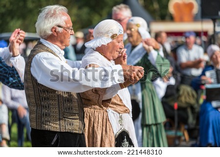 NIEUWEHORNE, THE NETHERLANDS - SEP 27: Elderly man and woman demonstrating an old Dutch folk dance during the agricultural festival Flaeijel on September 27, 2014, the Netherlands