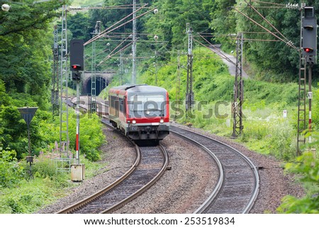 PUNDERICH, GERMANY - JUL 20: Train with unknown passengers driving through woods near the river Moselle in Germany on July 20, 2012 near Punderich, Germany