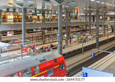 BERLIN, GERMANY - JULY 22: Unknown commuters traveling by train at the central station of Berlin on July 22, 2013 in the central station of Berlin, Germany