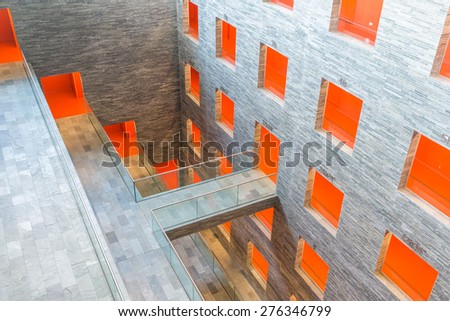 HILVERSUM, THE NETHERLANDS - MARCH 03: Modern interior Dutch institute Sound and Vision with several floors and orange painted passages on March 03, 2015 in Hilversum, The Netherlands