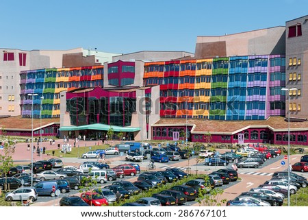 Zwolle, THE NETHERLANDS - JUN 11: People visiting the new modern Isala Hospital with a big car park in front of it on June 11, 2015 in Zwolle, the Netherlands