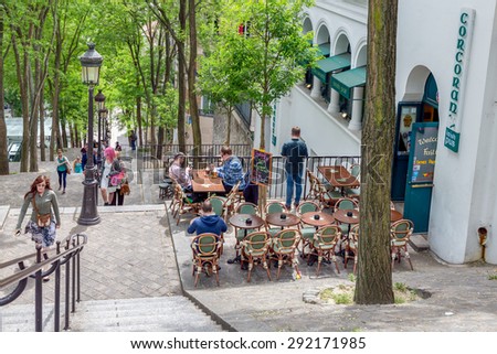 PARIS, FRANCE - May 28:  Tourists climbing the stairs with an Irish pub near Montmartre, one of the most touristic attractions of the city, on May 28, 2015, Paris, France
