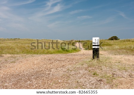 Dunes with wooden distance marker