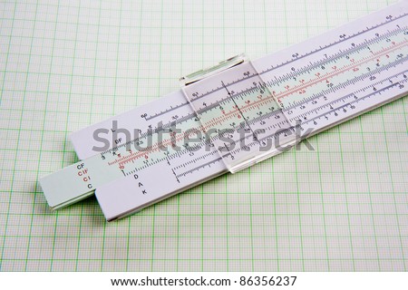 Old used slide rule on squared paper