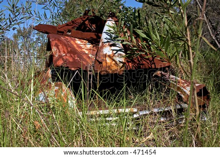stock photo Nature Reclaiming Rusted Car Wreck