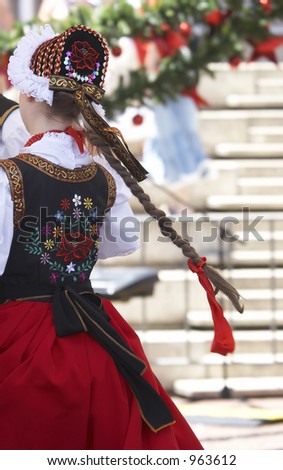 Polish Dancer with pony tail flying through the air