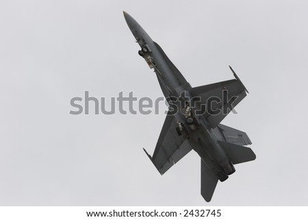 Jet fighter ascending after take off - the landing gear is folding in