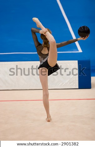 A female competitor in a Rhythmic Gymnastics event