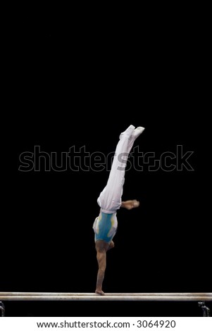 An athlete balancing on one hand on the parallel bars