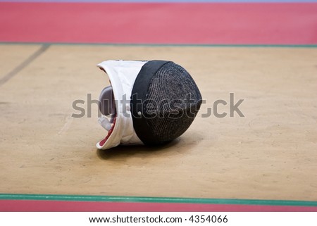 A fencing mask on the floor