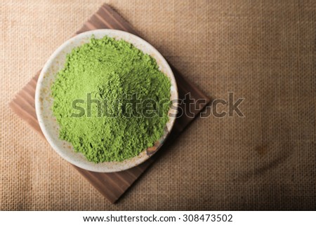 Green Tea powder on the plate, Natural Style. Focus on Green Tea powder.